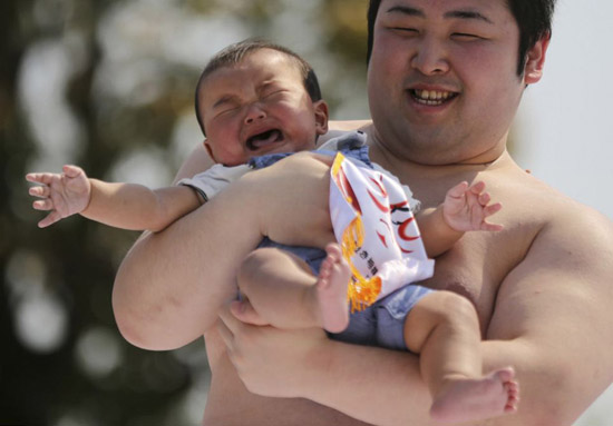 日本传统节日相扑选手比赛惹婴孩哭
